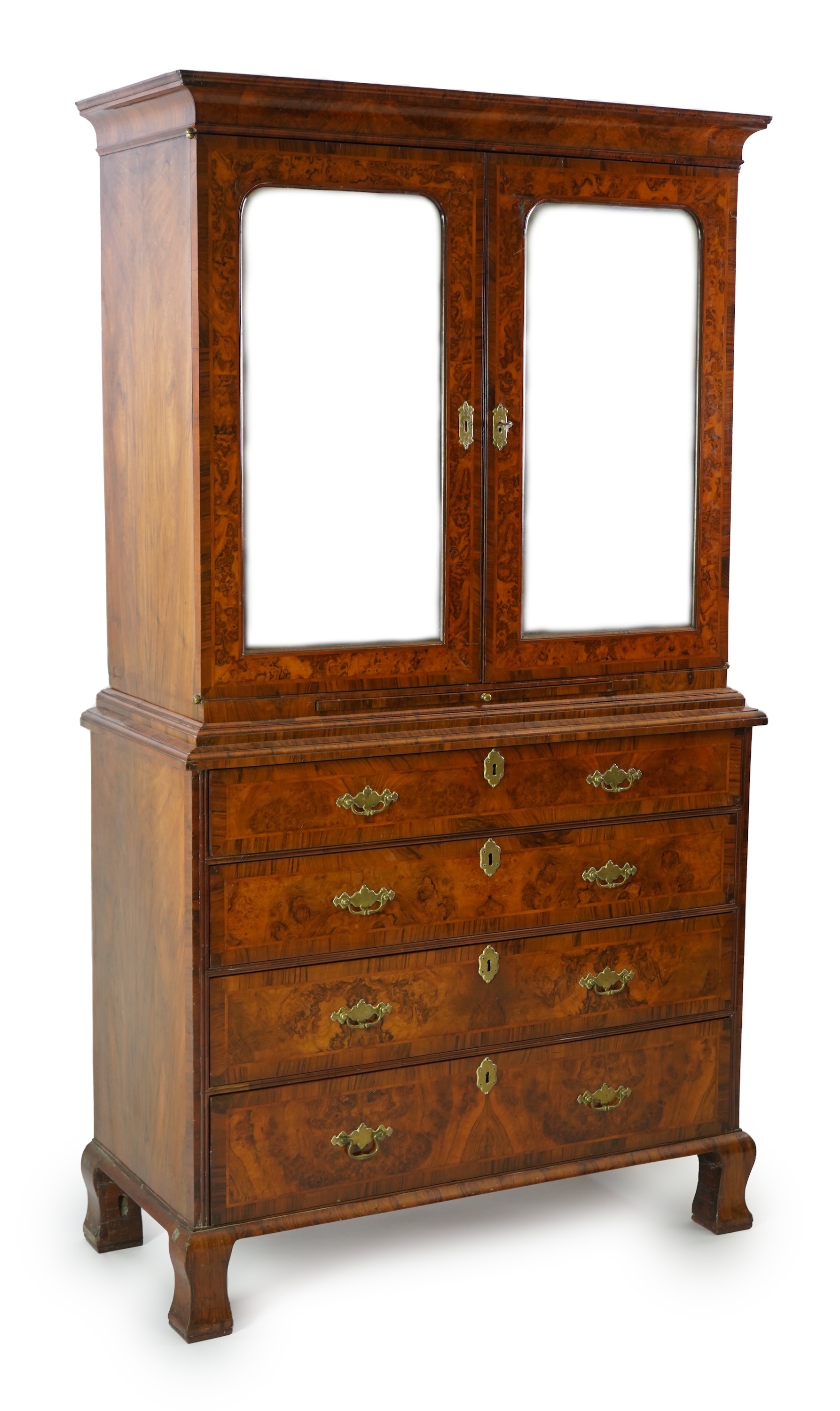 An early 18th century figured and burr walnut cabinet on chest